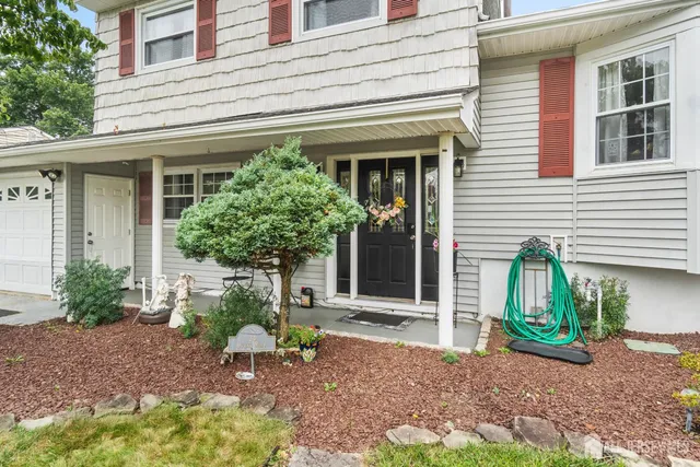 a house that has a potted plant and a table and chair