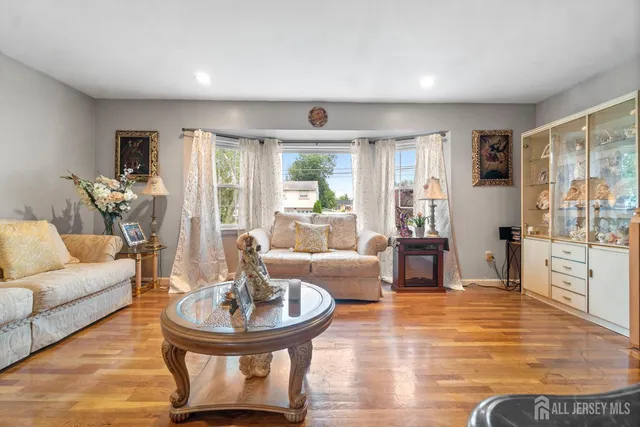 a living room with fireplace furniture and a large window