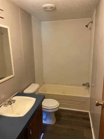 a bathroom with a toilet a sink and bathtub