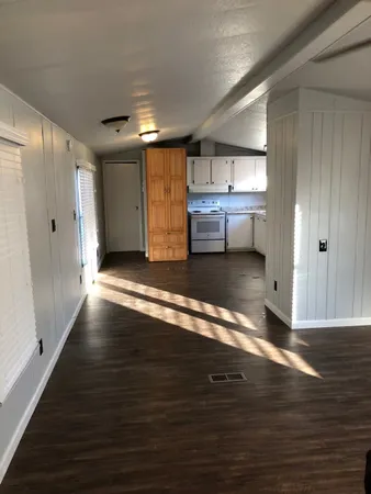 a view of a room with wooden floor