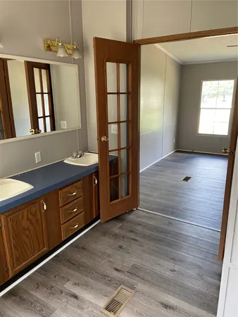a view of wooden floor and windows in a room