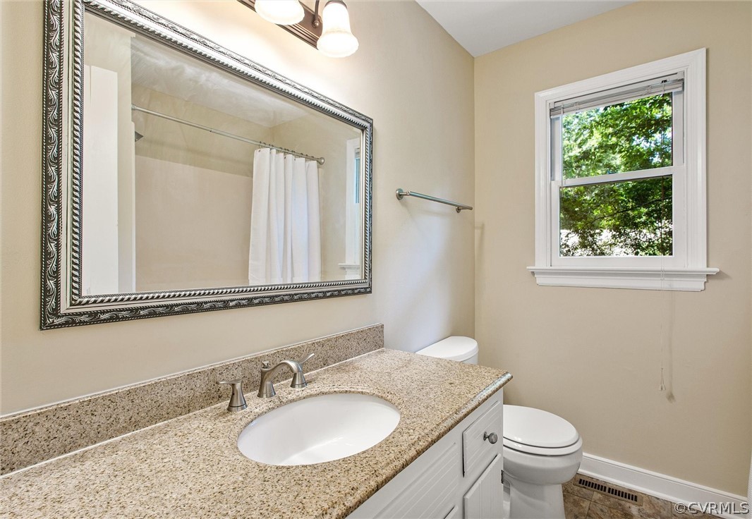 14000 Turtle Hill Road Midlothian, VA 23112 - Photo 22 of 37 a bathroom with a granite countertop sink a toilet and a mirror