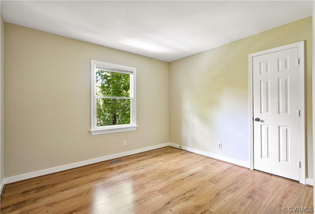 14000 Turtle Hill Road Midlothian, VA 23112 - Photo 24 of 37 an empty room with wooden floor and windows