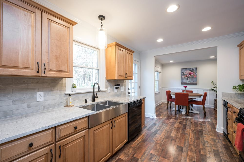 4709 Randolph Court Raleigh, NC 27606 - Photo 9 of 27 Granite countertops, deep stainless steel farmhouse sink, gas range and maple cabinets in the kitchen