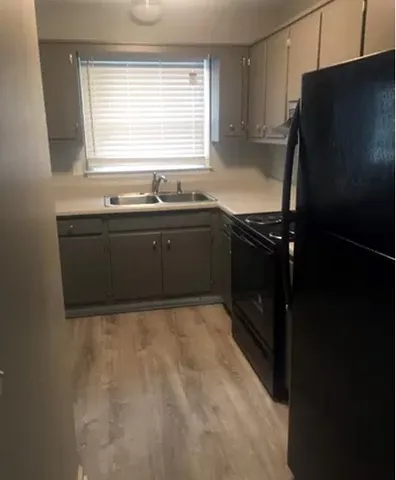 a kitchen with a refrigerator and a stove