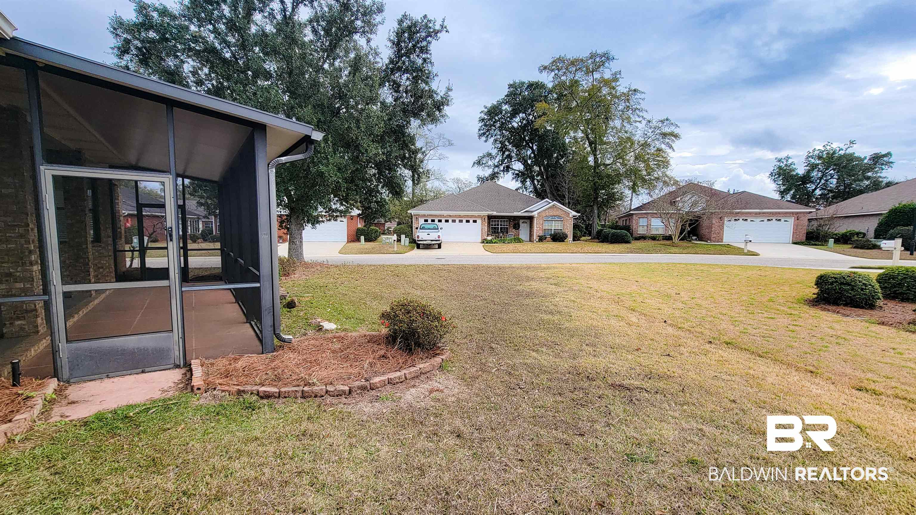 214 Hemingway Loop Foley, AL 36535 - Photo 55 of 67 View of green lawn featuring a sunroom