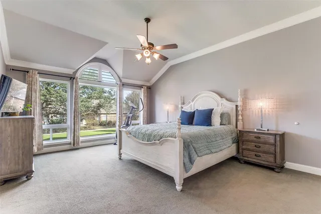a spacious bedroom with a bed chandelier and window