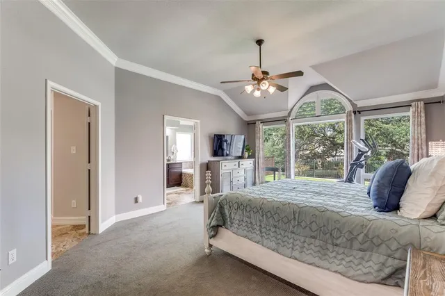 a bedroom with a large bed and a large window