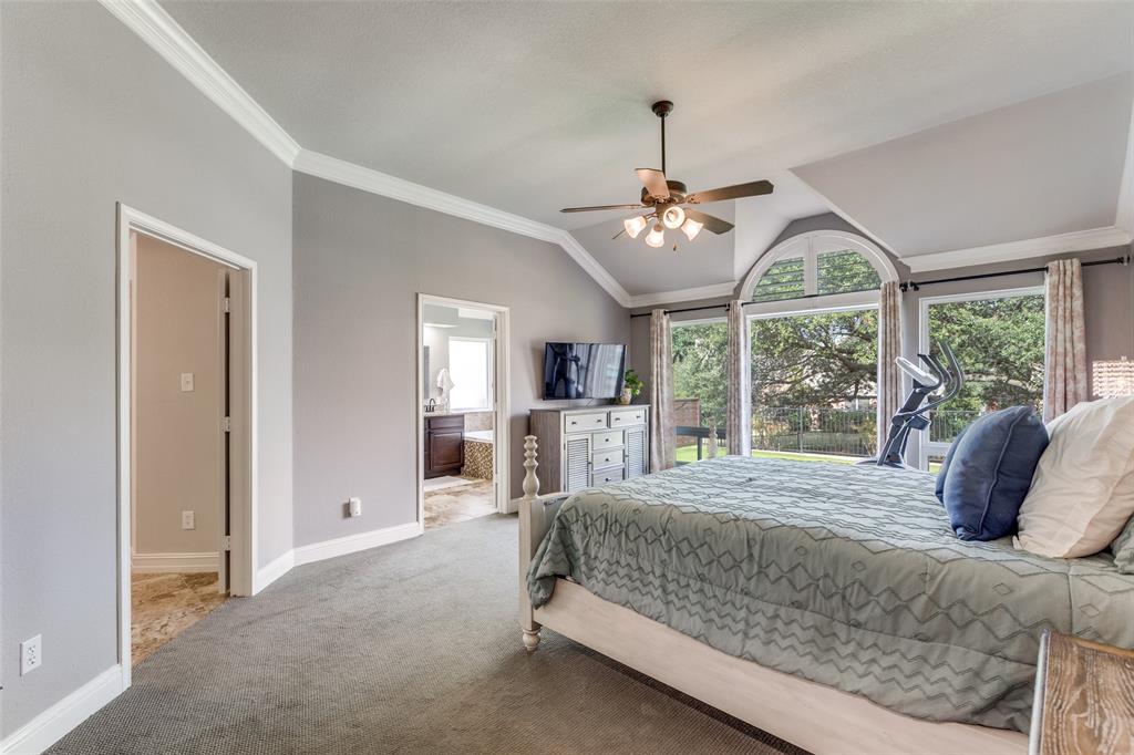 2704 Wind Ridge McKinney, TX 75072 - Photo 17 of 29 a bedroom with a large bed and a large window