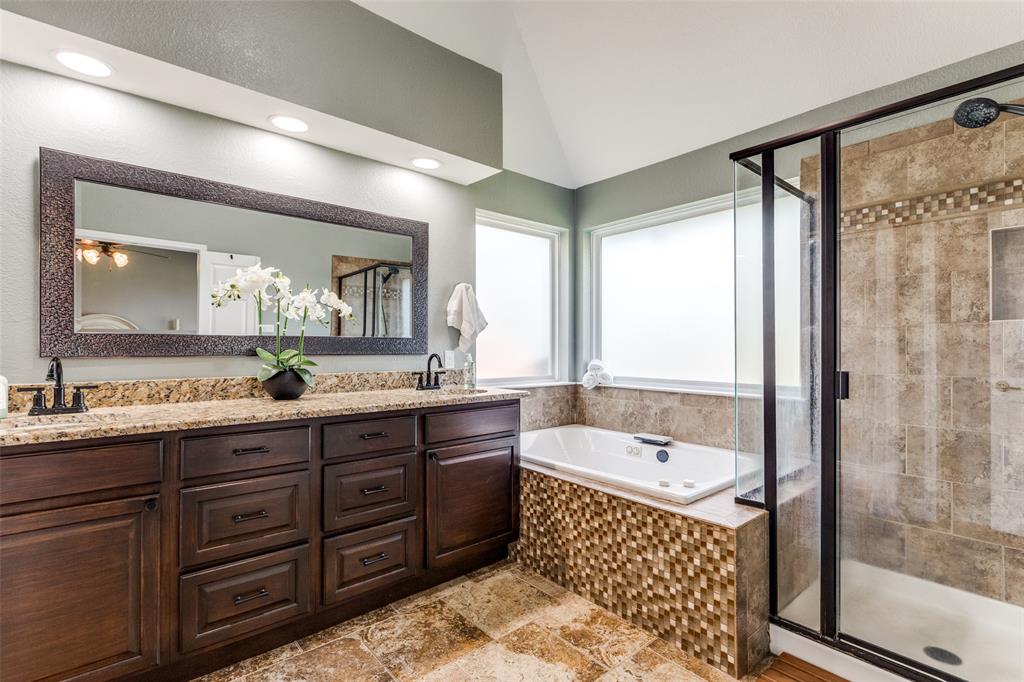 2704 Wind Ridge McKinney, TX 75072 - Photo 18 of 29 a bathroom with a tub a sink and mirror