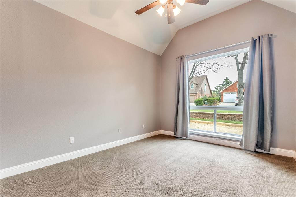 2704 Wind Ridge McKinney, TX 75072 - Photo 19 of 35 2nd bedroom, featuring vaulted ceiling, new windows, ceiling fan and carpeting