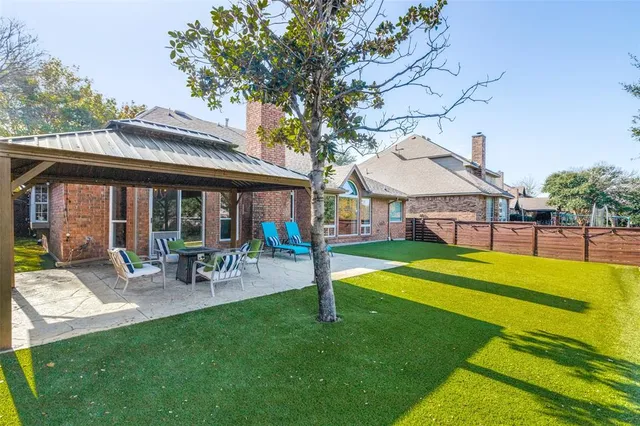 a view of a house with a yard patio and swimming pool