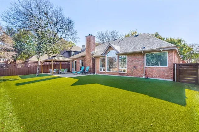 a front view of a house with swimming pool having outdoor seating