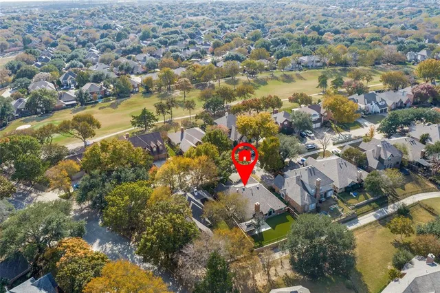 an aerial view of residential houses with outdoor space