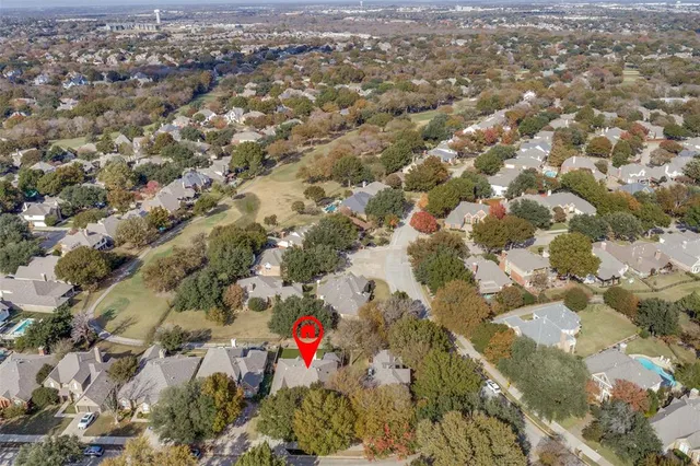 an aerial view of residential houses with outdoor space