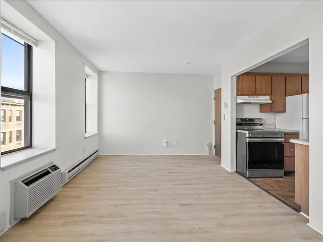 a view of a kitchen with a sink and dishwasher a refrigerator with wooden floor