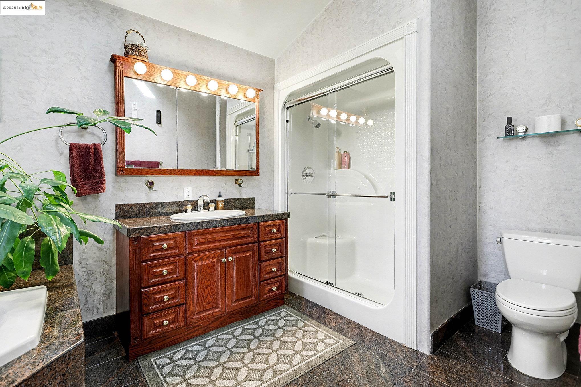 3614 Kay Court Fremont, CA 94538 - Photo 14 of 35 Full bathroom featuring granite floors, vanity, sunken jetted tub and a stall shower