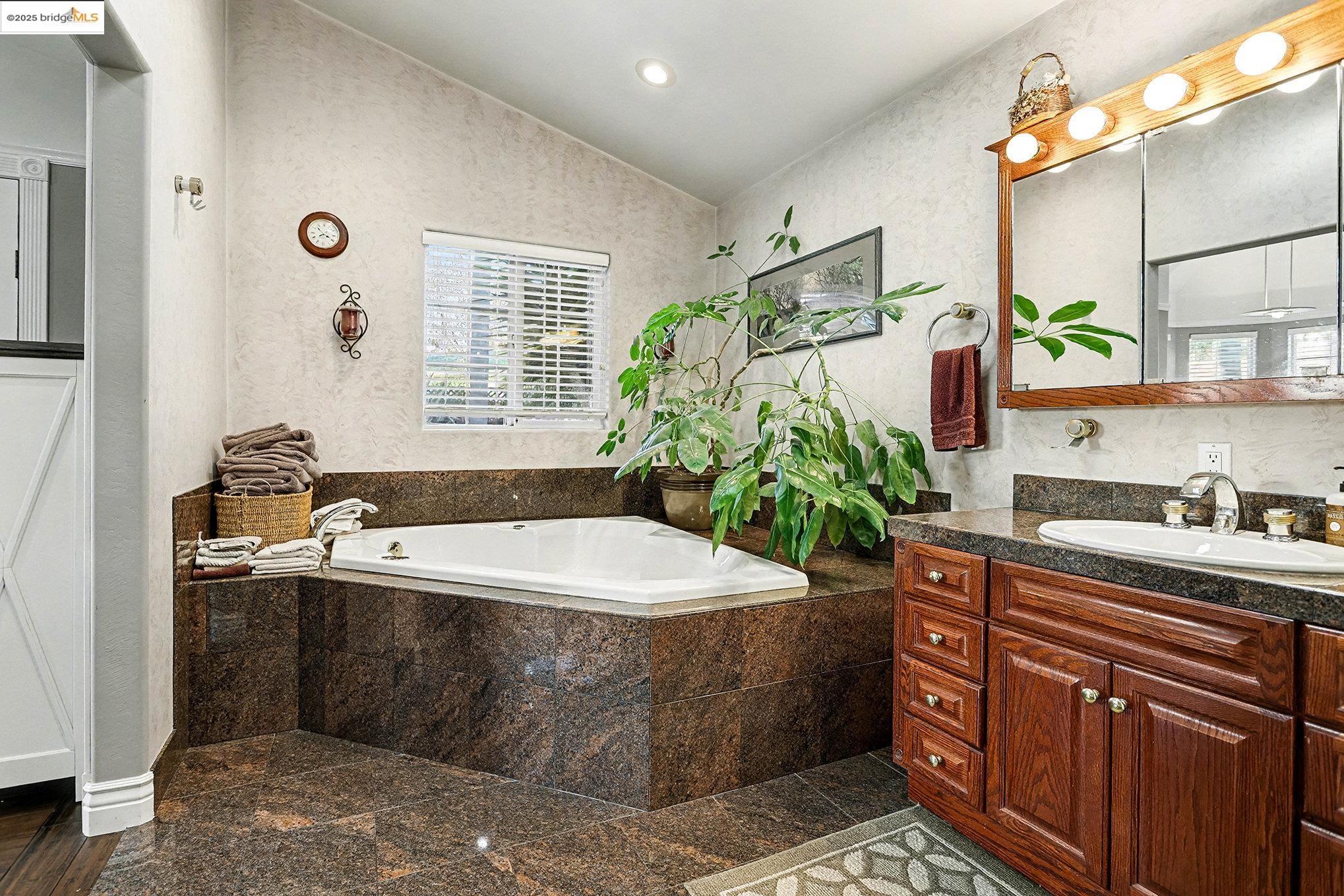 3614 Kay Court Fremont, CA 94538 - Photo 15 of 35 Full bath featuring vaulted ceiling, vanity, a bath, recessed lighting, and granite floors