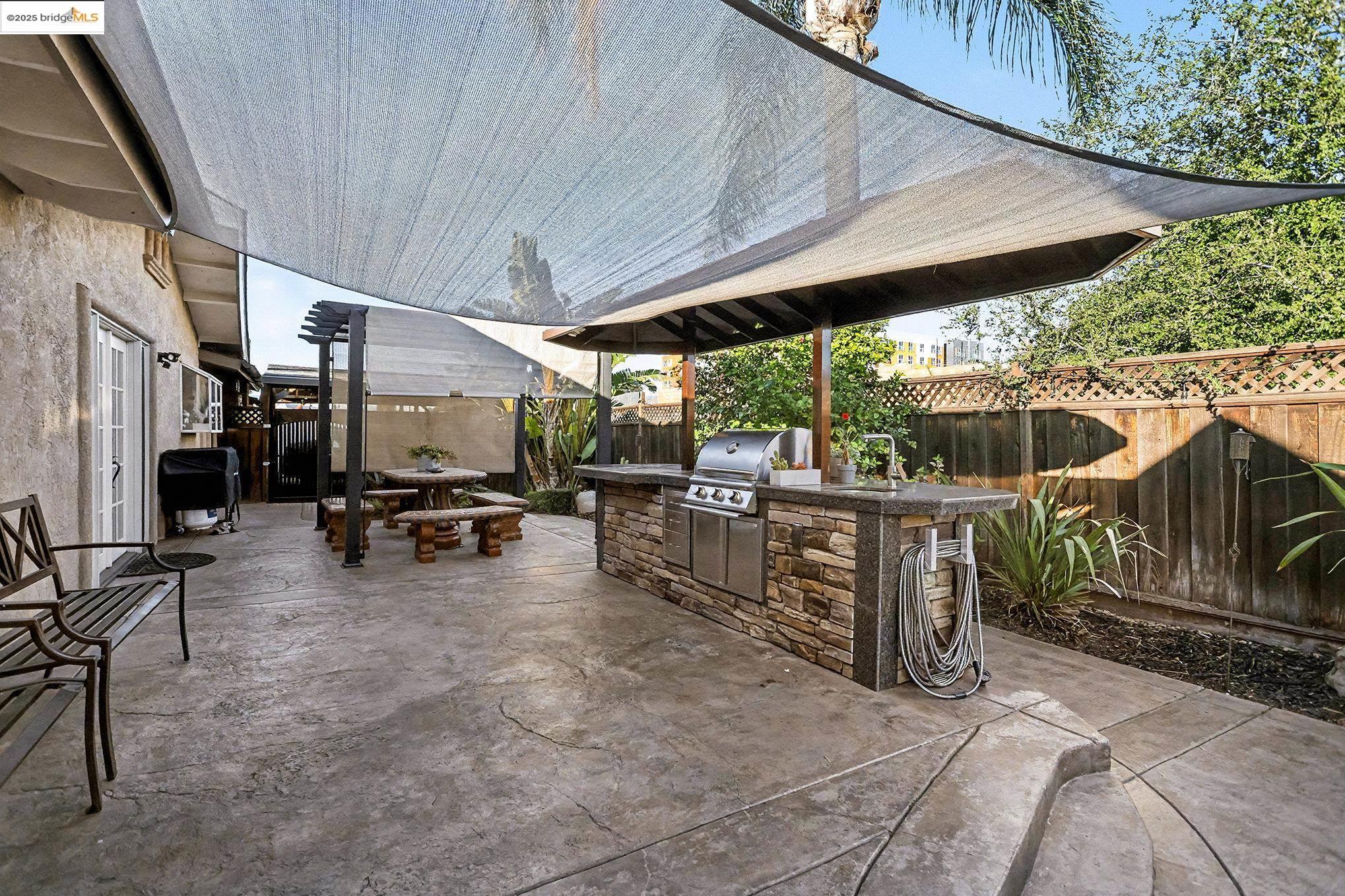 3614 Kay Court Fremont, CA 94538 - Photo 24 of 35 Fenced backyard with an outdoor kitchen, a patio area, and outdoor dining area