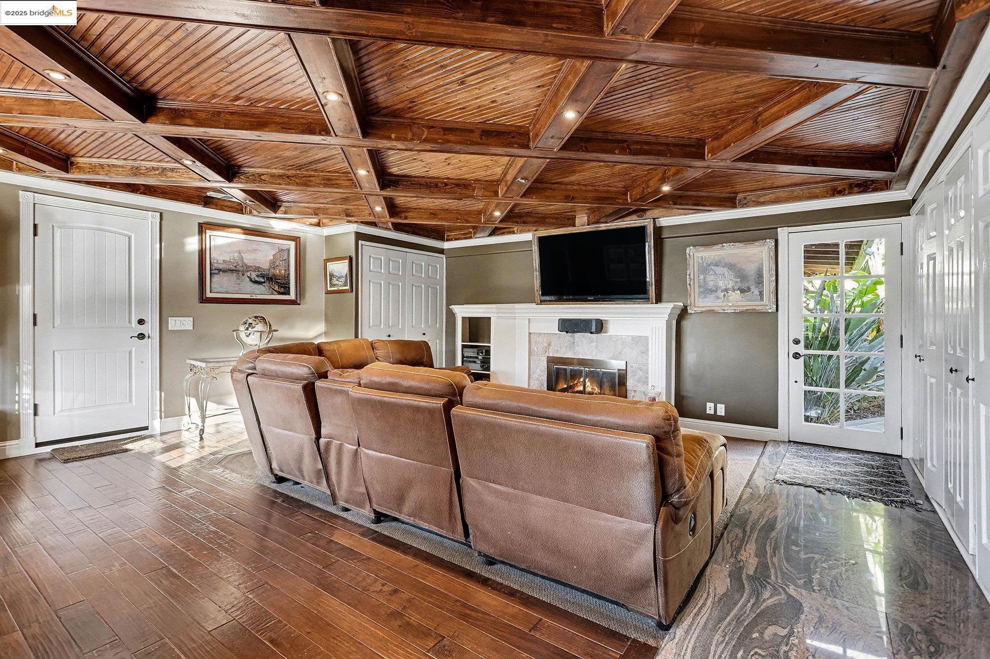 3614 Kay Court Fremont, CA 94538 - Photo 9 of 35 Living room with a custom wood ceiling with exposed beams, coffered ceiling, and a fireplace with built in TV