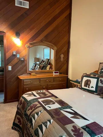 a bed sitting in a bedroom next to a window