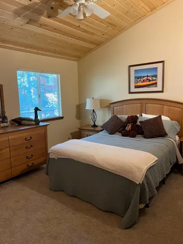 a bedroom with a bed and window