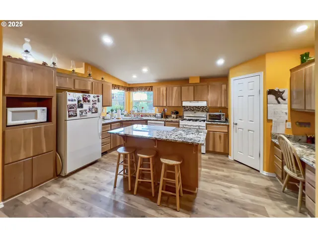 a kitchen with a stove a refrigerator and a sink