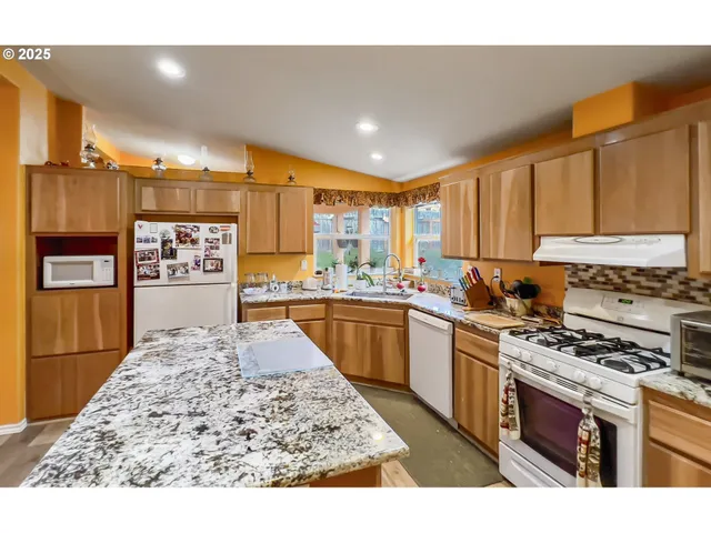 a living room with dining table and wooden floor