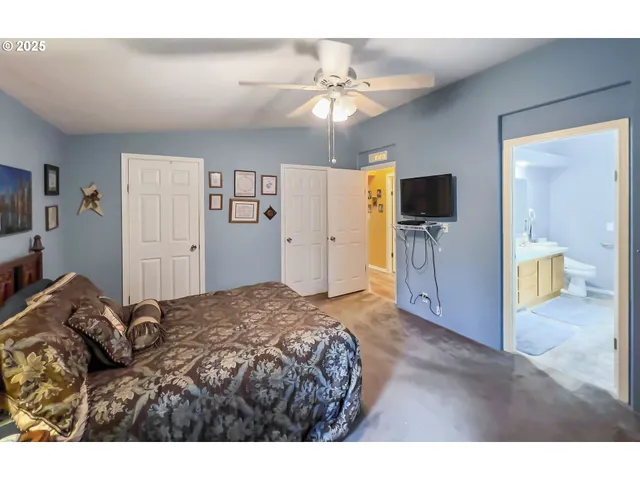 a bathroom with a double vanity sink toilet and shower