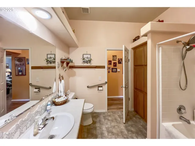 a living room with furniture and a painting on the wall