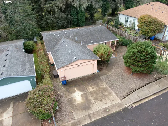 an aerial view of a house with garden space and street view