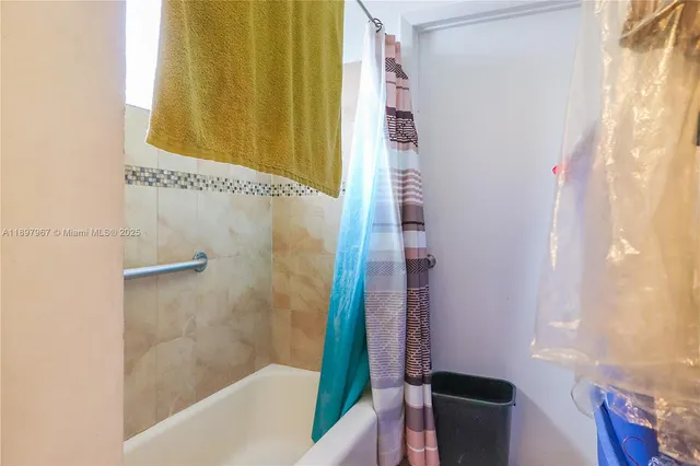 a bathroom with a bathtub and shower