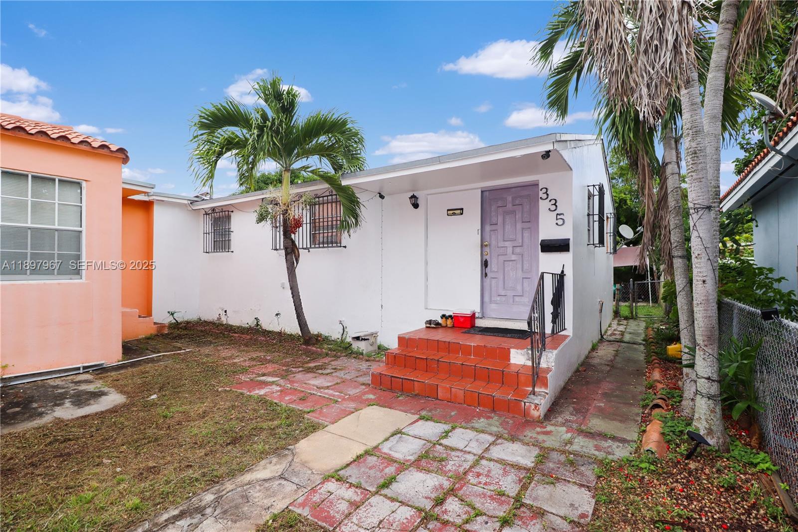 333 Southwest 30th Avenue Miami, FL 33135 - Photo 13 of 27 a backyard of a house with potted plants and large tree