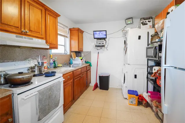 a kitchen with stainless steel appliances a refrigerator sink and cabinets