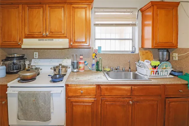 a kitchen with a sink and cabinets