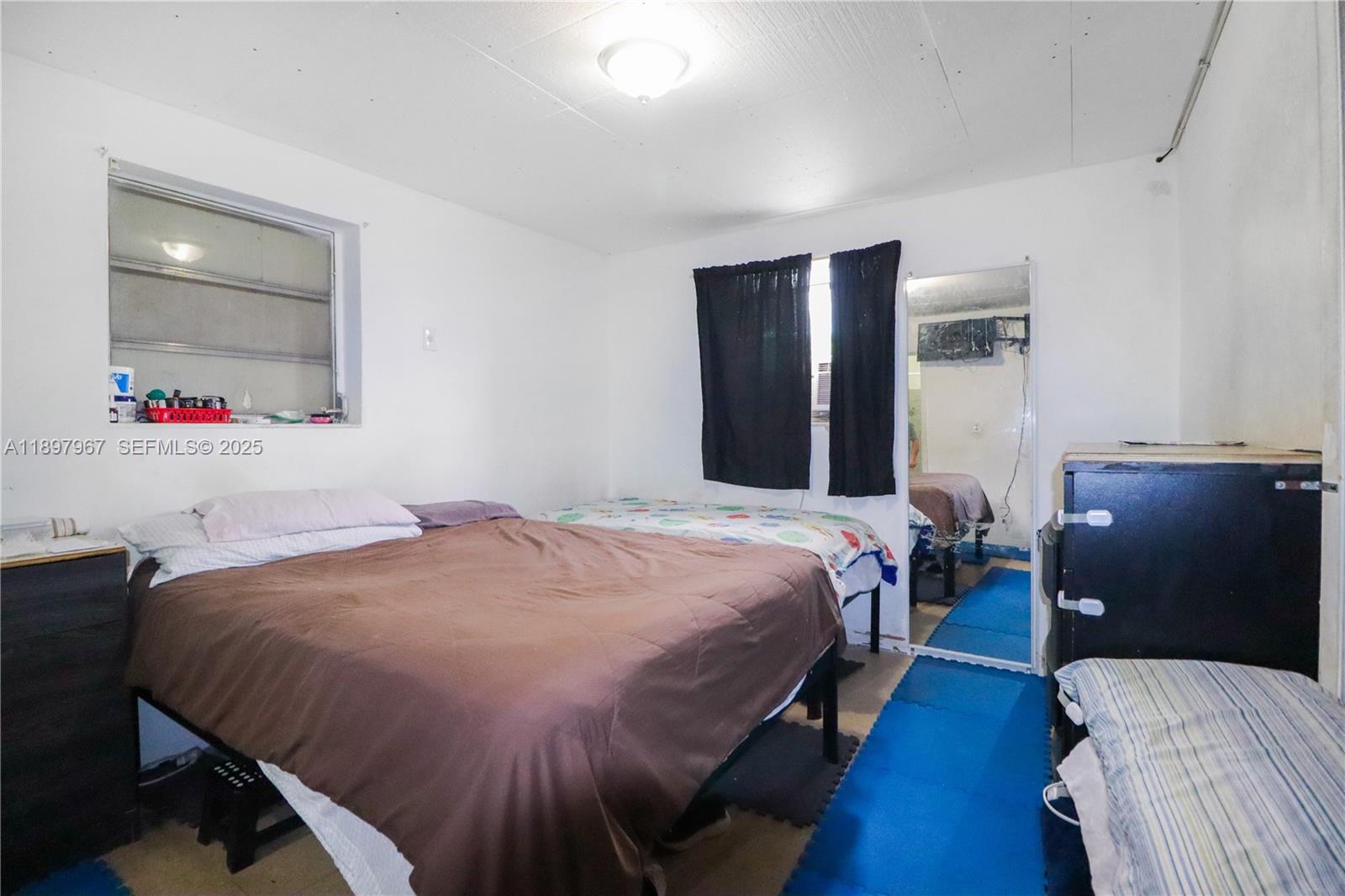 333 Southwest 30th Avenue Miami, FL 33135 - Photo 20 of 27 a bedroom with a bed and wooden floor