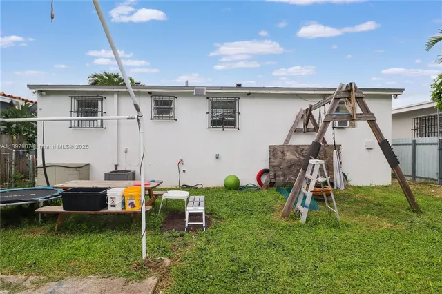 a backyard of a house with table and chairs