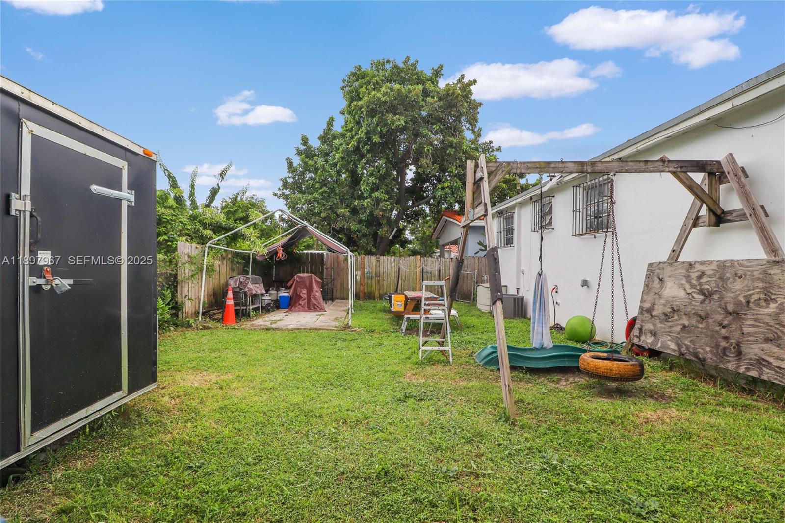 333 Southwest 30th Avenue Miami, FL 33135 - Photo 26 of 27 a backyard of a house with table and chairs