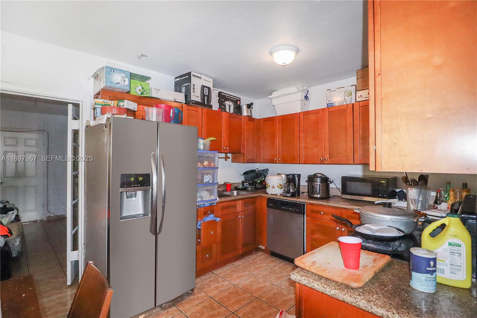 333 Southwest 30th Avenue Miami, FL 33135 - Photo 4 of 27 a kitchen with stainless steel appliances granite countertop a refrigerator a sink and a stove