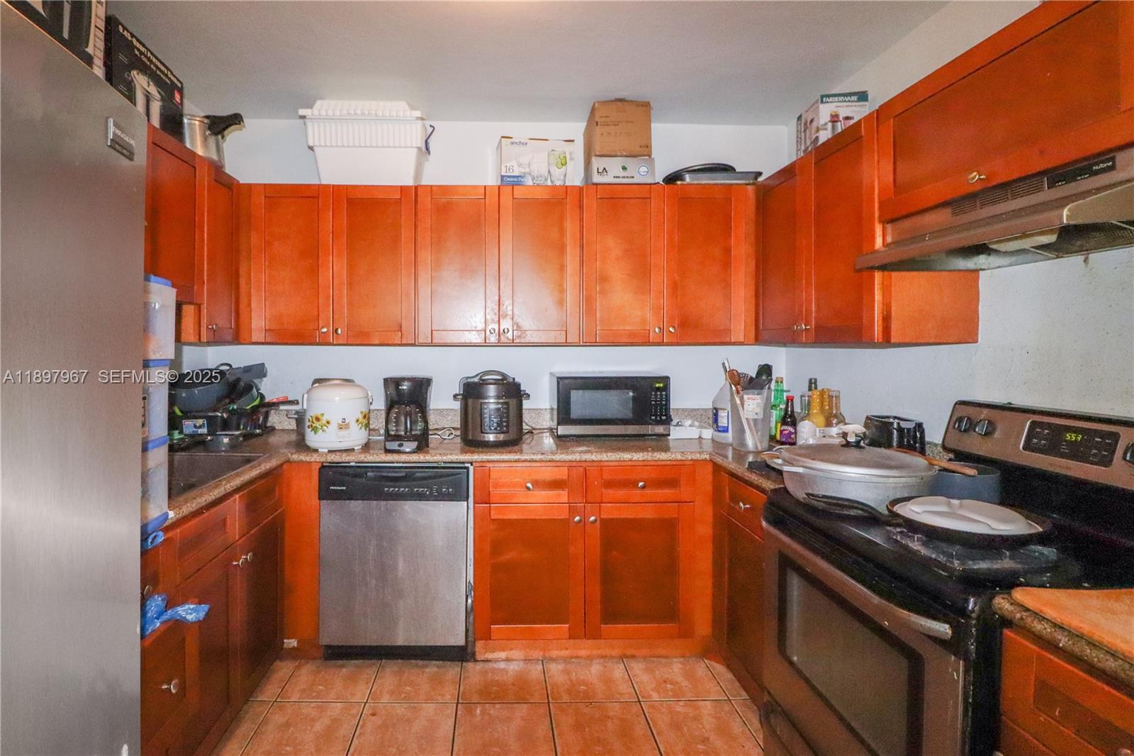 333 Southwest 30th Avenue Miami, FL 33135 - Photo 5 of 27 a kitchen with stainless steel appliances a stove a sink and a refrigerator