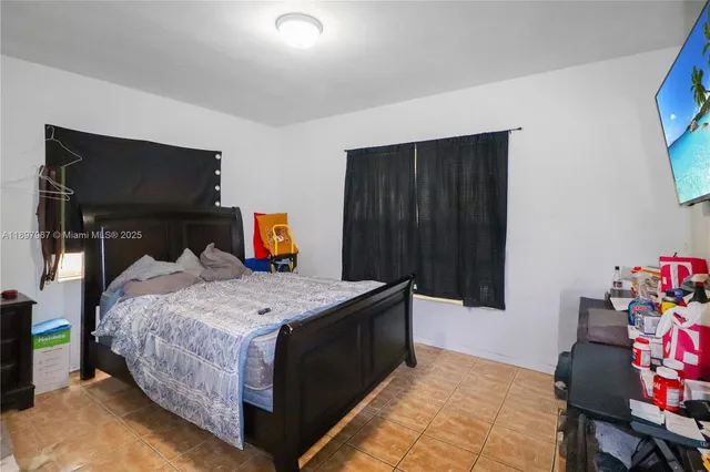 a bedroom with a bed and a television