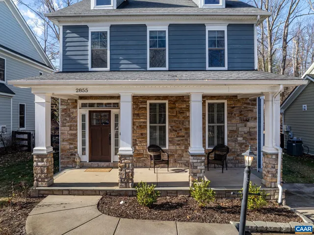 a front view of a house with garden and plants