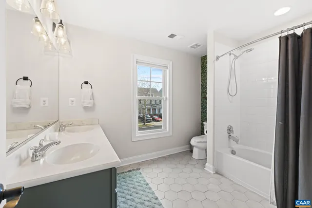 a bathroom with a sink toilet tub and shower
