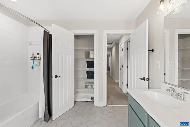 a spacious bathroom with a shower and a sink