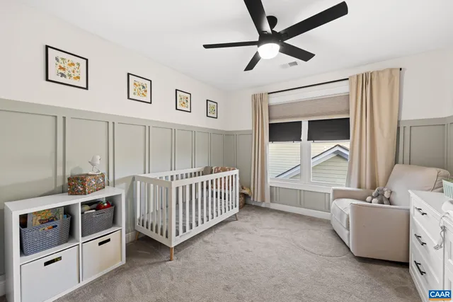 a living room with a baby crib furniture and a window