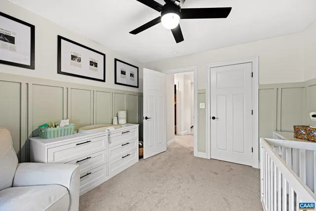 a spacious bedroom with a bed and a furniture