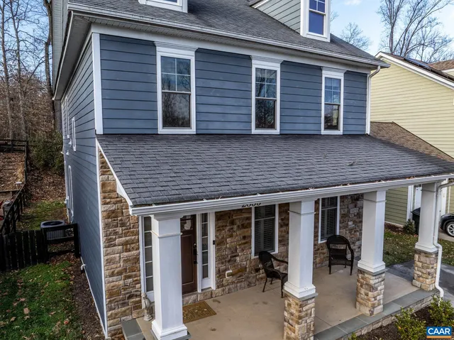 an aerial view of a house with a yard