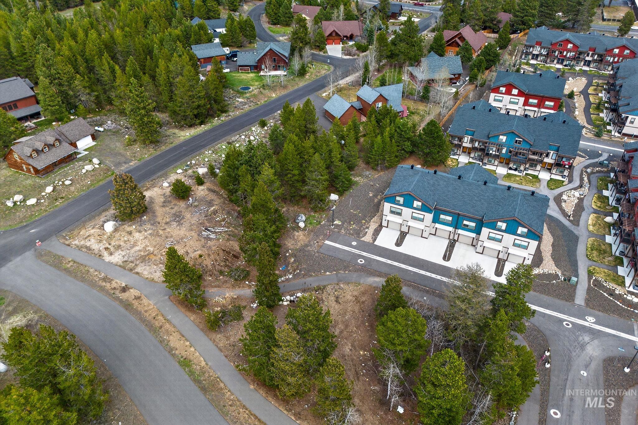 311 Broken Ridge Way McCall, ID 83638 - Photo 35 of 44 Contemporary townhomes featuring dark gray roofs, light-colored facades, and blue-accented upper levels