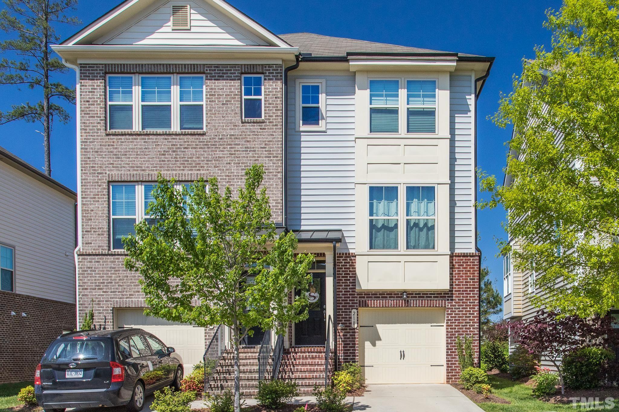 a front view of a house with plants