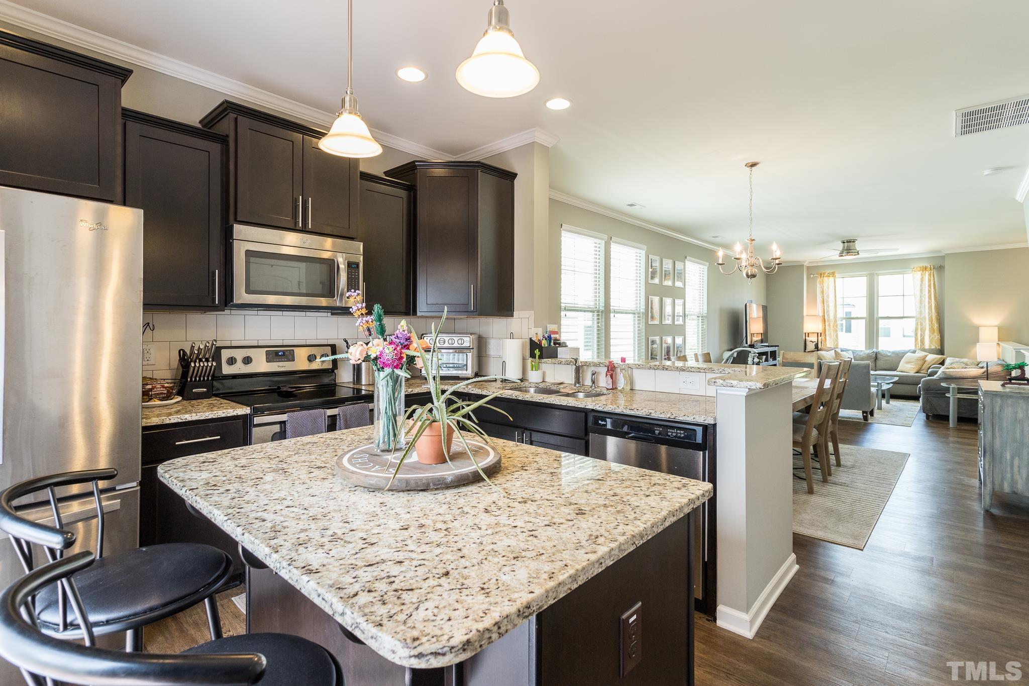 218 Irving Way Durham, NC 27703 - Photo 12 of 41 a kitchen with a counter top space a sink stainless steel appliances and cabinets